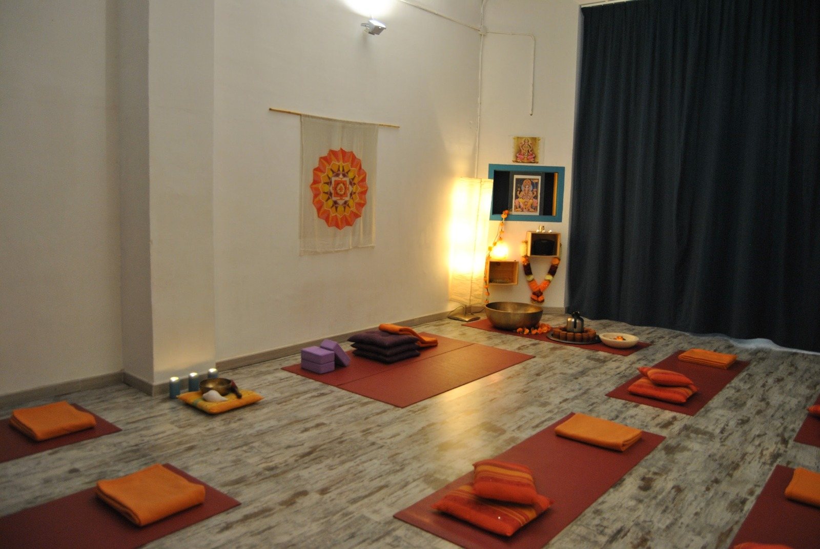 The candlelit studio at Jardín de Hara, mats and cushions laid out in rows